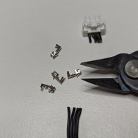 Fan cable already cut, sitting next to wire cutters and JST pins.jpg