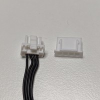 The fan cable before cutting its connector, next to the JST connector it will be replaced with.jpg